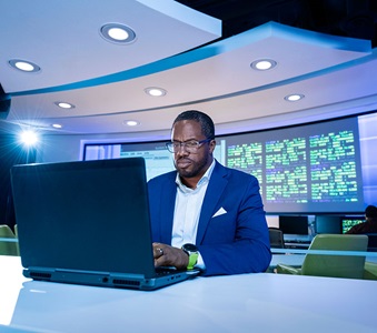 african american man typing on laptop