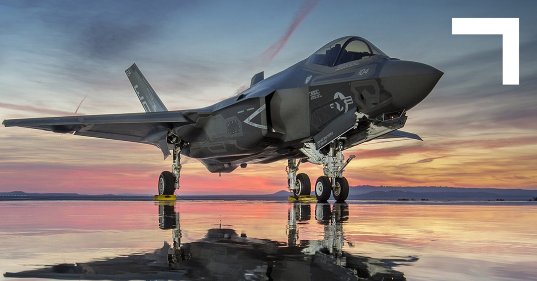 Fighter jet on a dry lakebed at sunset