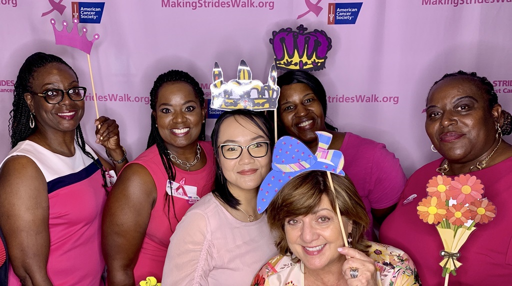 Group of diverse women using dress up accessories at a charity event