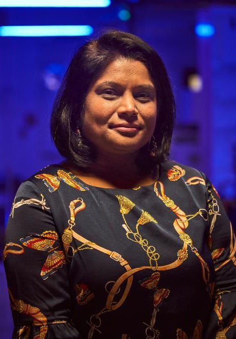 woman standing in room with blue background