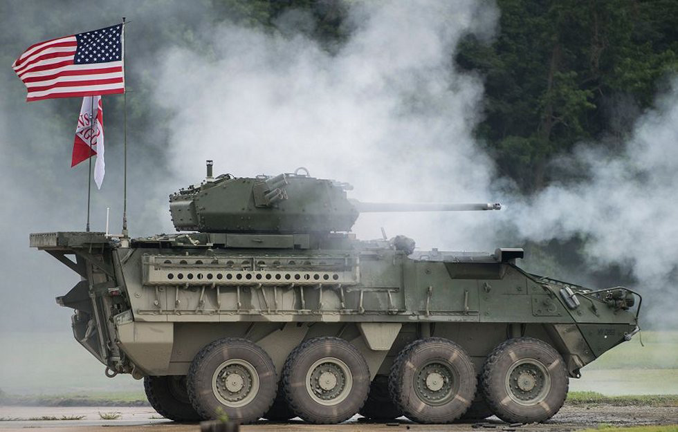 tank with American flag and Bushmaster chain gun