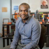 black man smiling in a lab