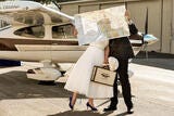man and woman with map in front of small plane