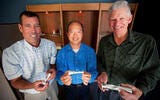 Three Males holding polarizers with their hands 