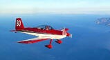 pilot in small airplane over the ocean