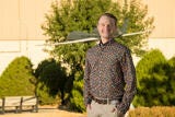 white male standing in front of model plane