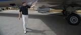 pilot walking below aircraft wing