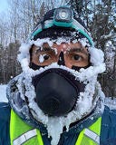 male with mask on covered in snow