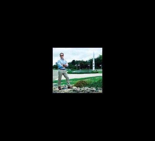 man standing in front of missle model