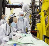 technicians in bunnysuits working on spacecraft