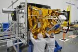 Engineers working on spacecraft
