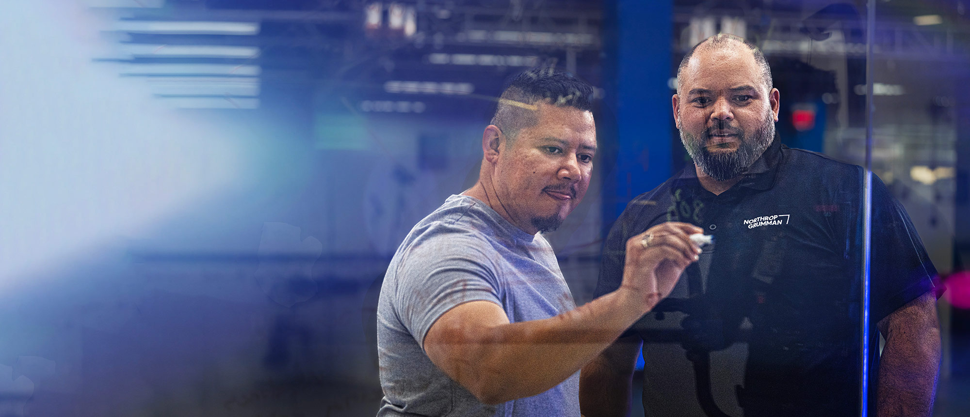 two men drawing on a digital board