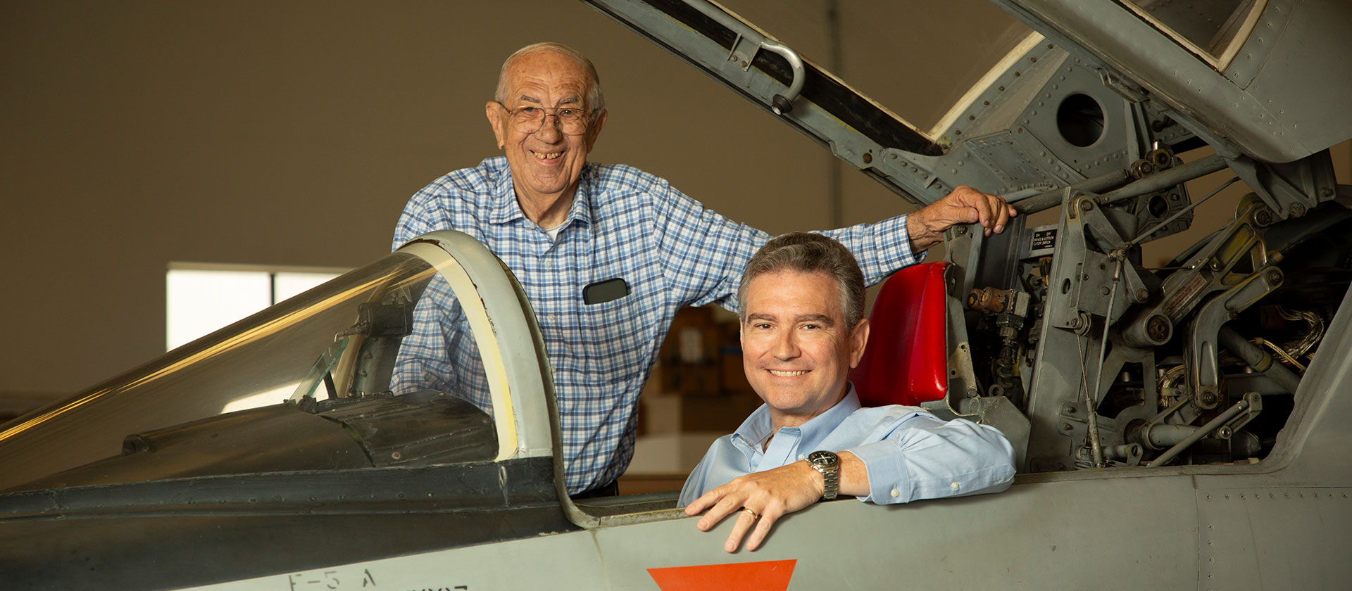 Two men and an F-5 fighter jet