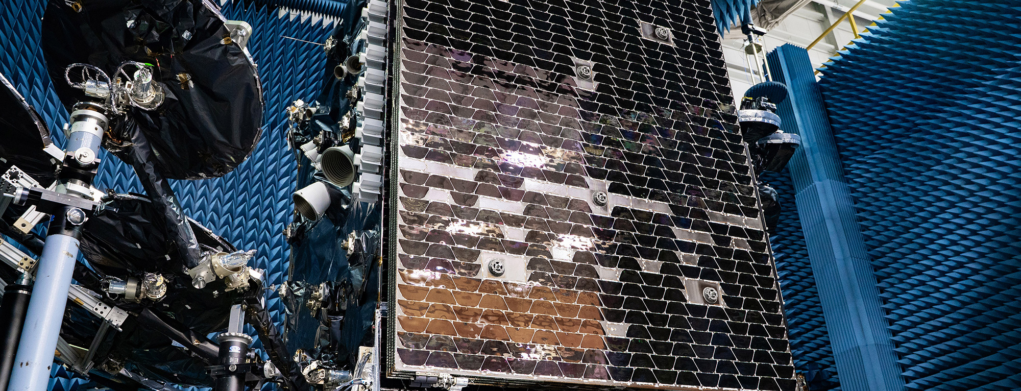 satellite being worked by technicians.