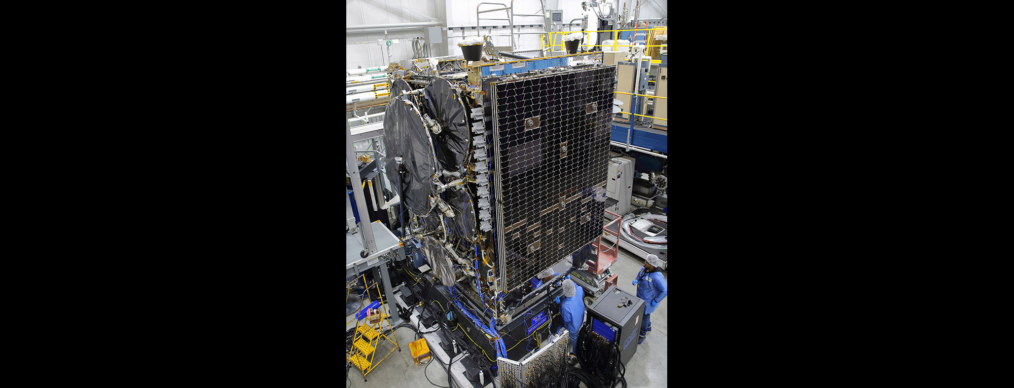 satellite being worked by technicians.