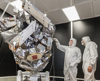 technicians working on satellite in high bay