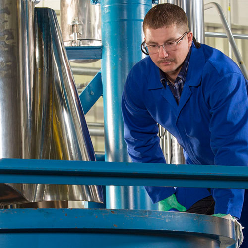 man working on solid rocket motor