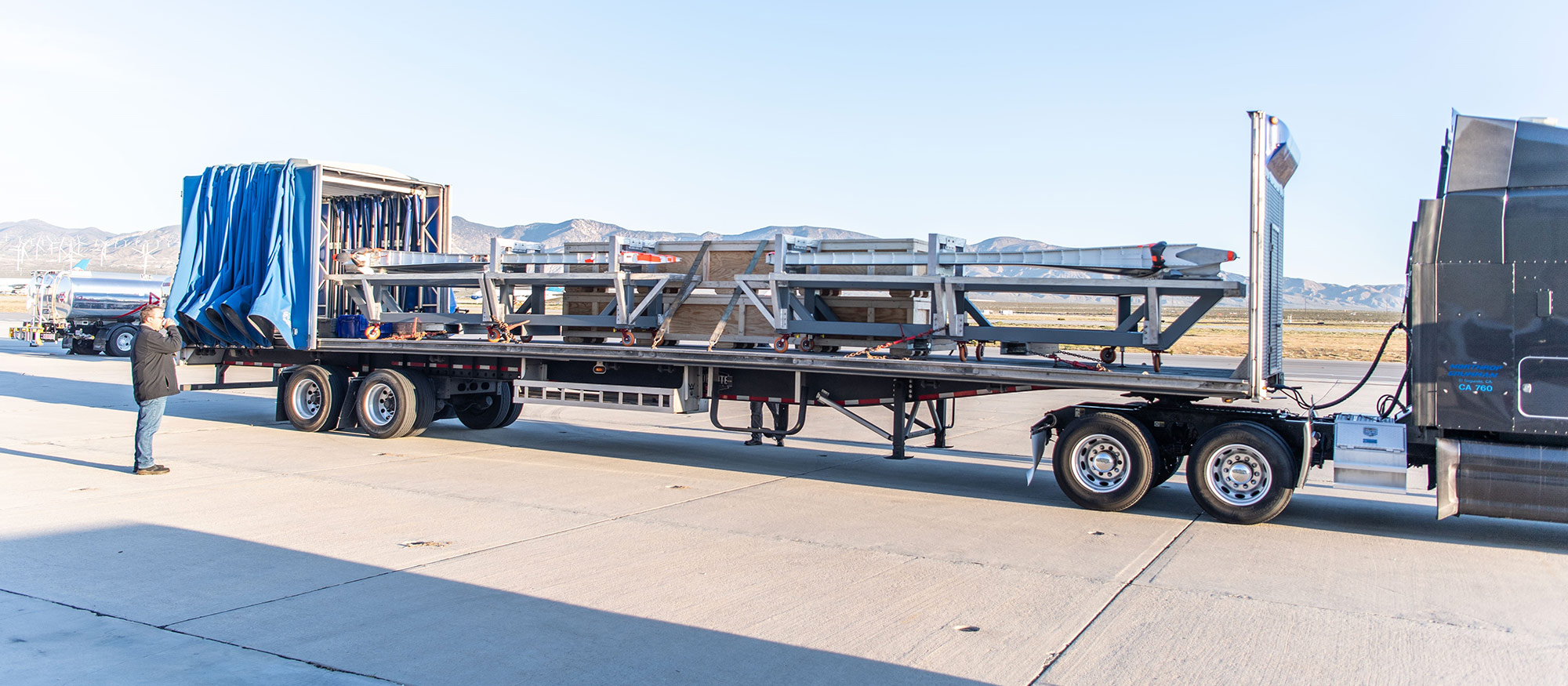 wings of plane being shipped by truck