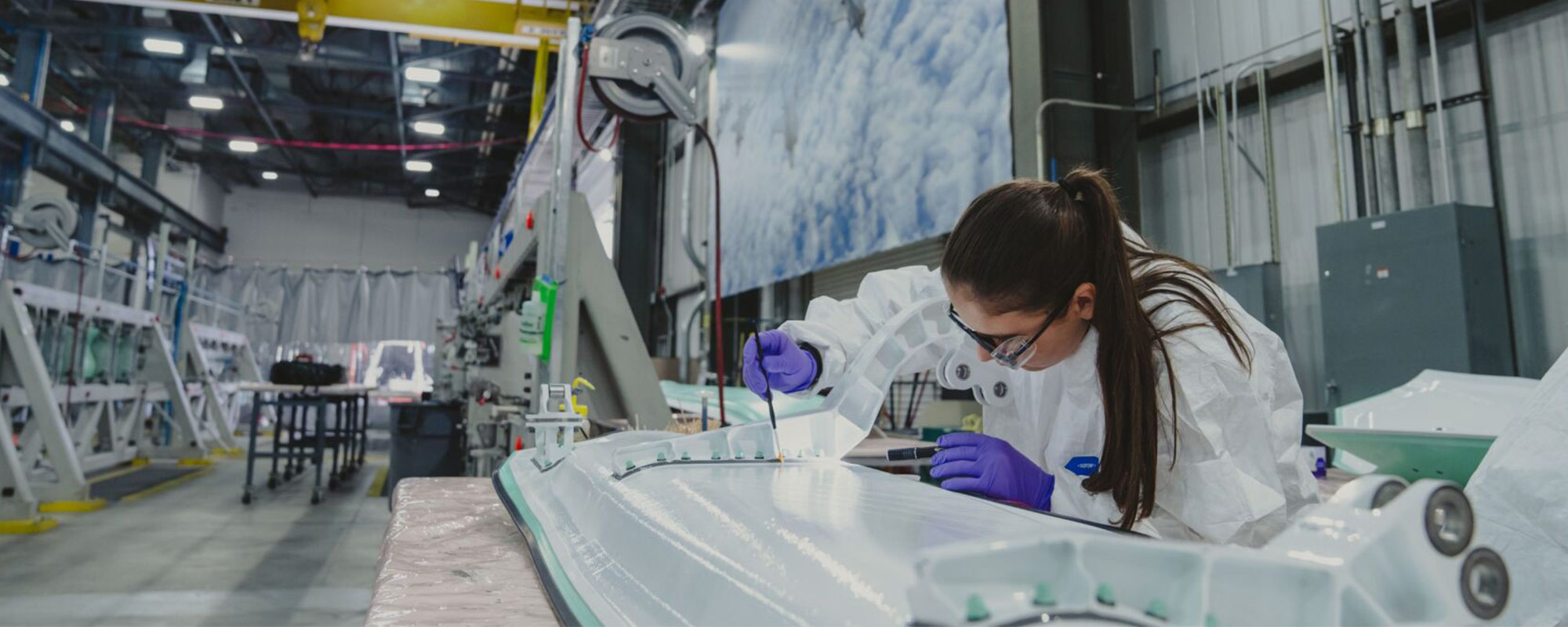 woman working on aircraft component in manufacturing facility
