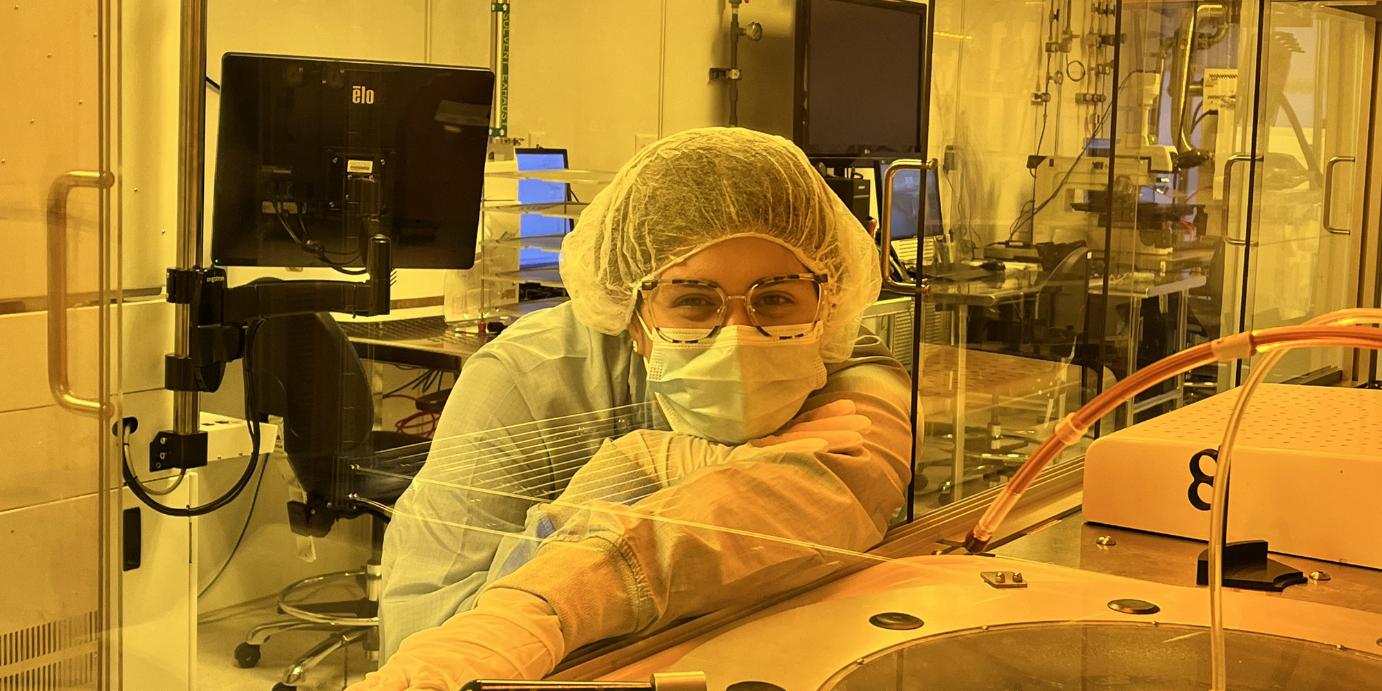 woman in microelectronics lab wearing bunny suit