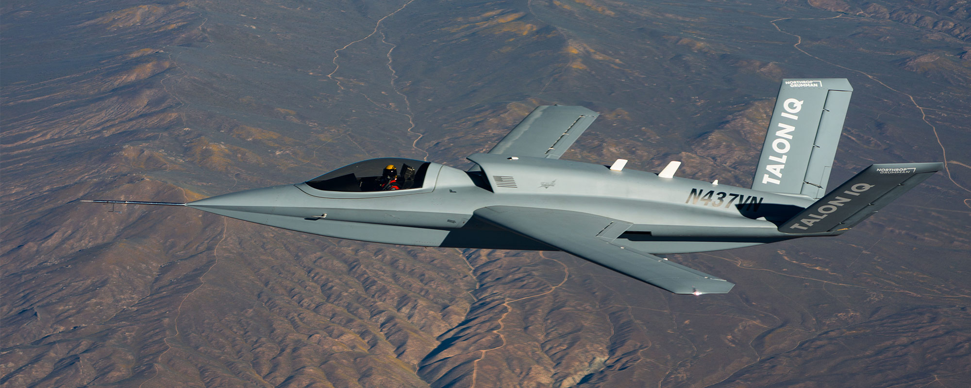 Talon IQ aircraft flying about mountains