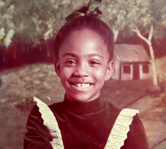 old color photograph of little girl smiling 