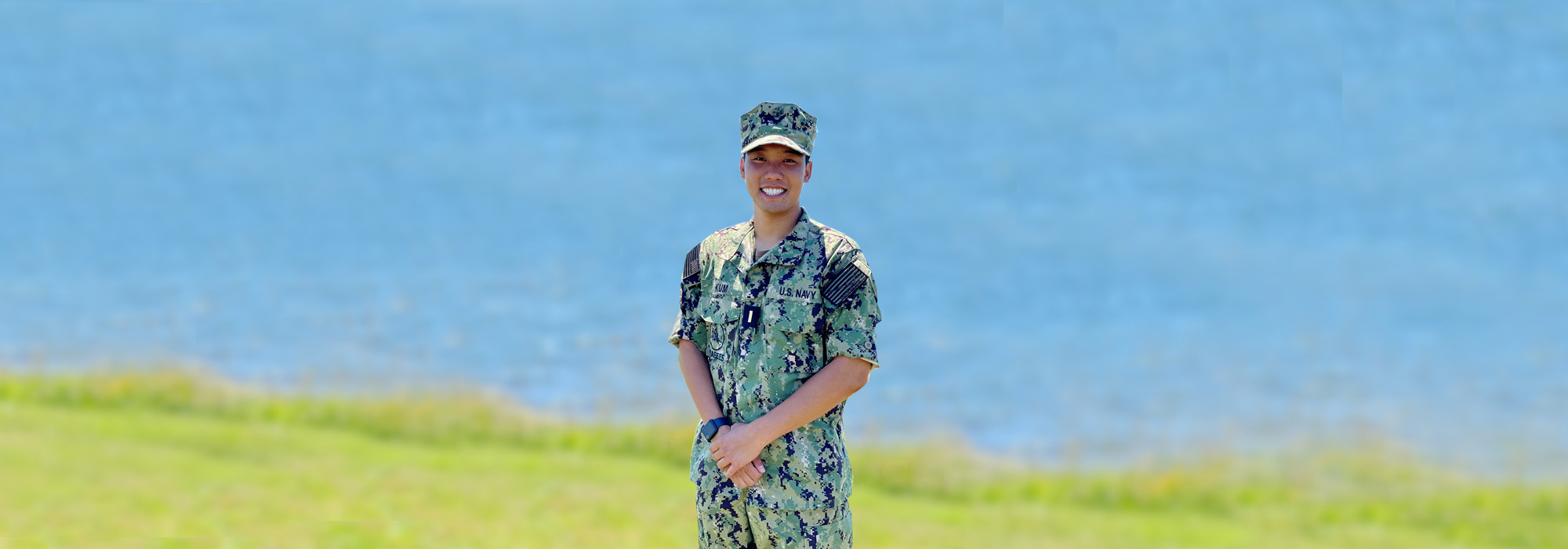 Serving the Mission-Hero u.s. navy sailor posed in front of lake.