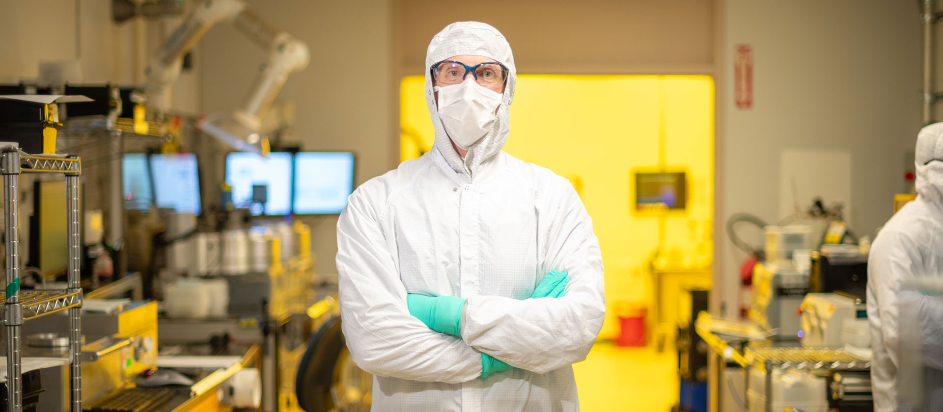 man in clean room clothes in lab