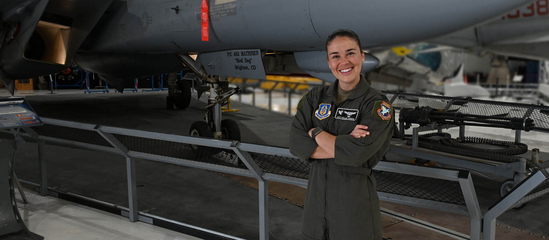 female military pilot in flight uniform smiling