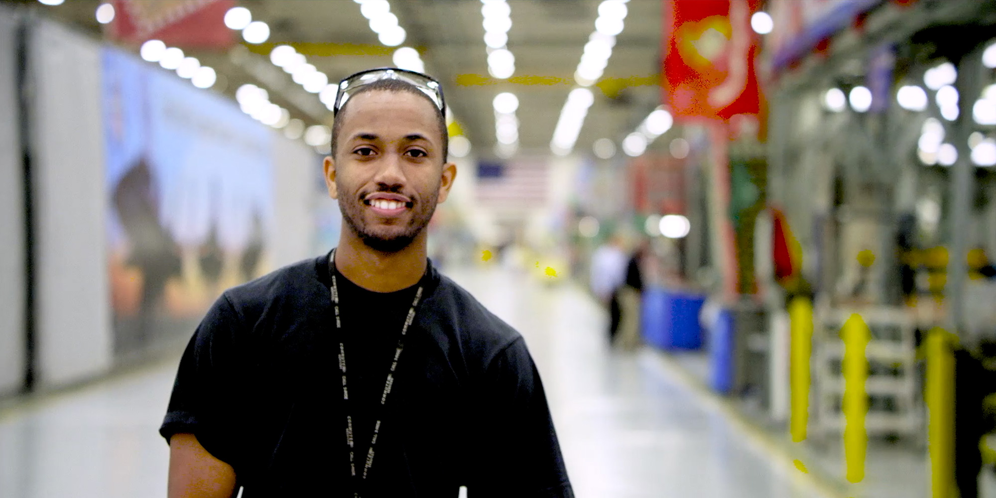 Building Our Diverse Workforce black man smiling in large hangar