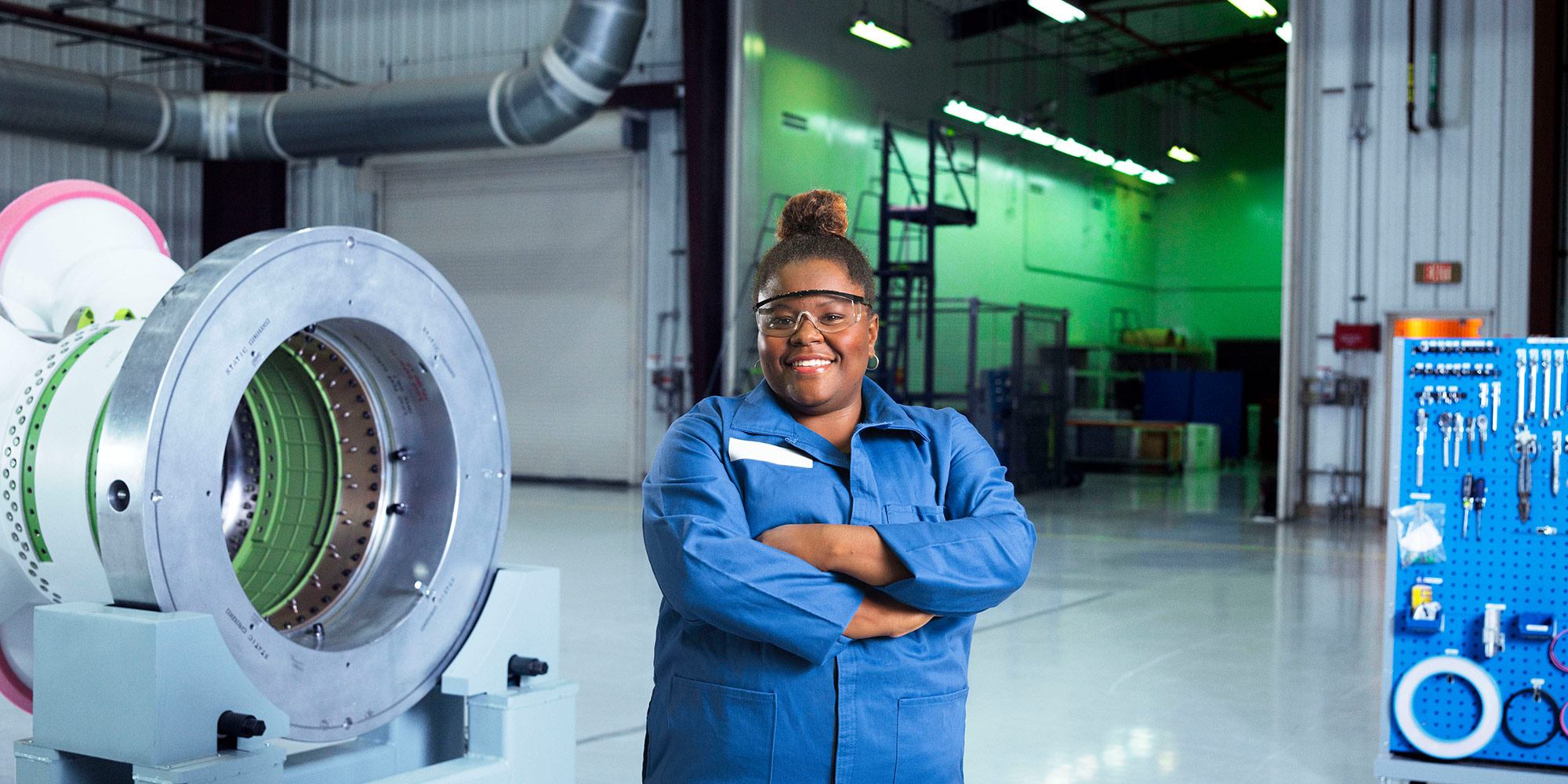 Diversity Drives Innovation at Northrop Grumman black female employee in blue jumpsuit in space facility