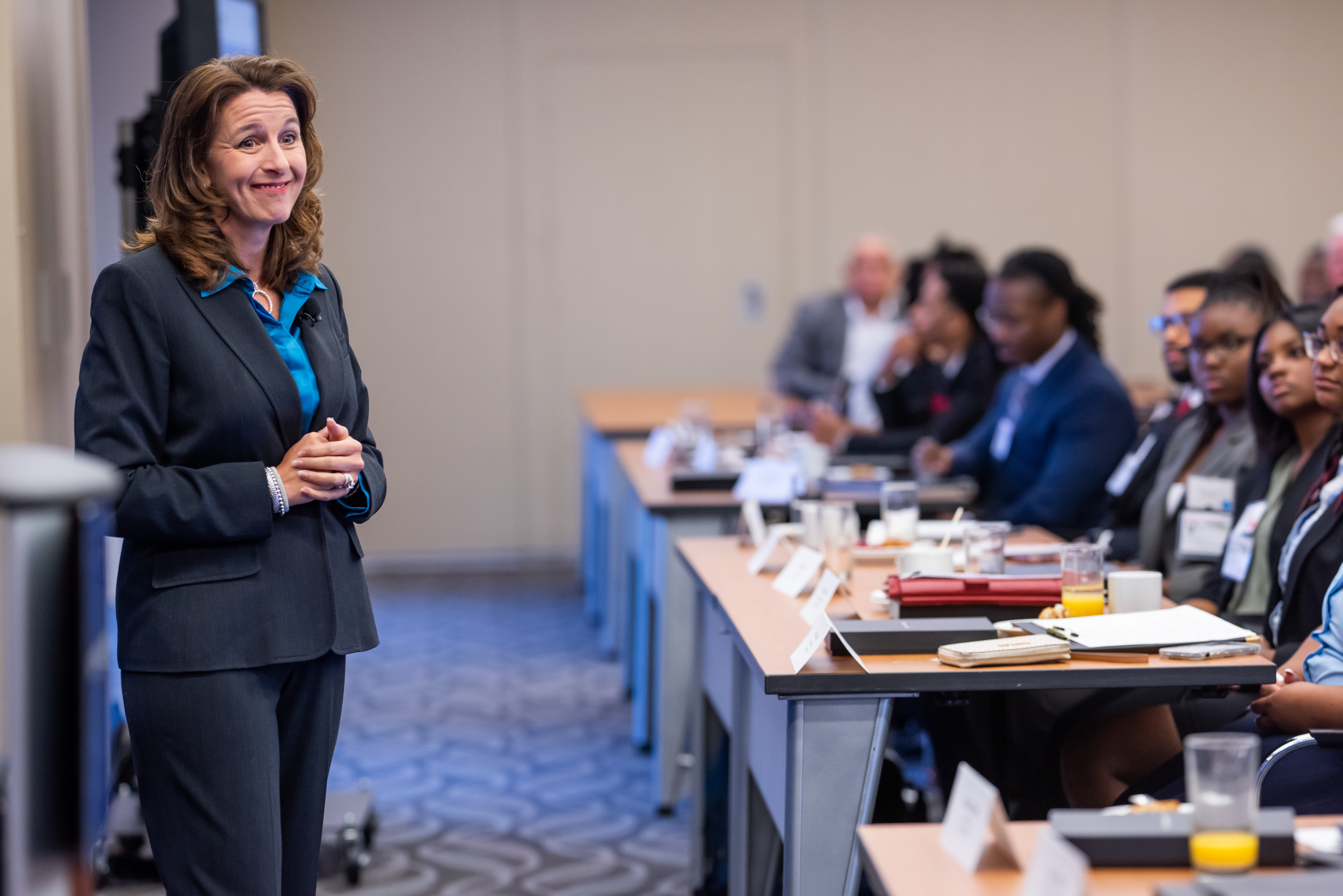 Female CEO speaking to room of individuals