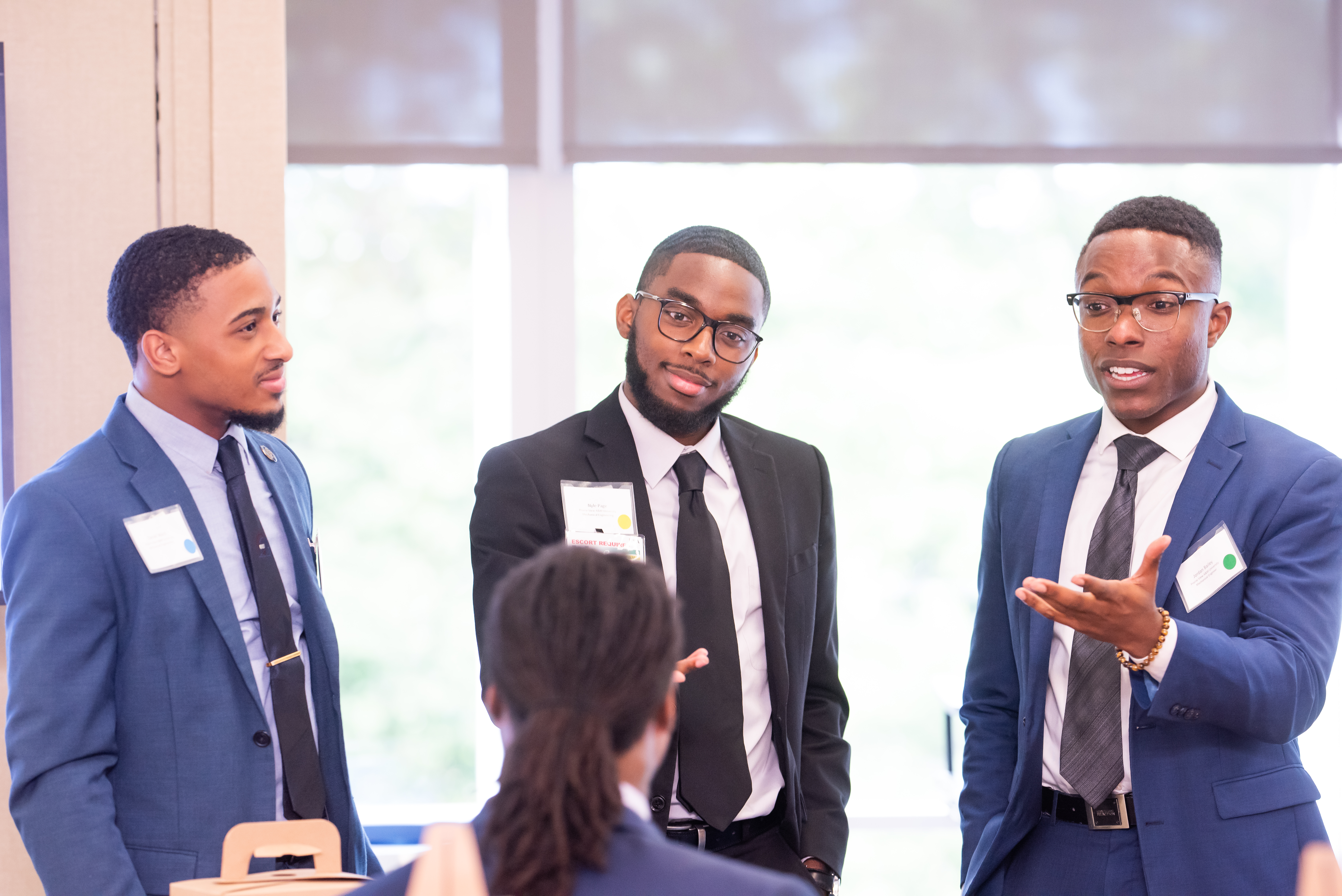 Three young males speaking