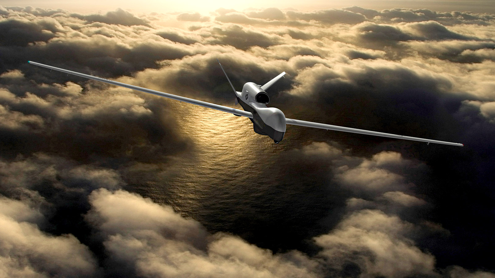 MQ-4C Triton unmanned plane flying in clouds above ocean