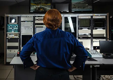 woman looking at monitors