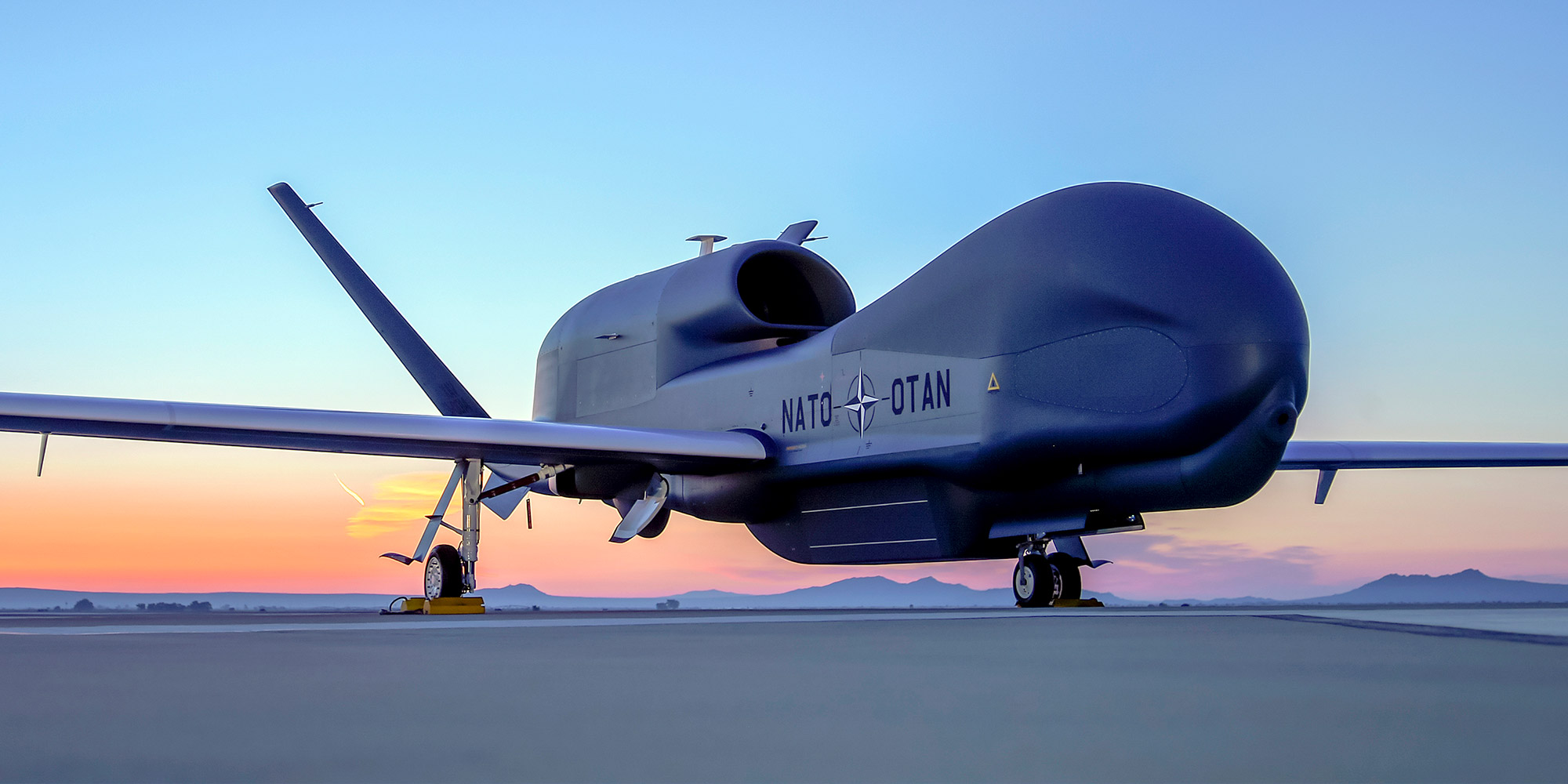 NATO AGS Unmanned plane on tarmac at sunset